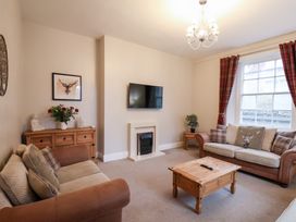 A living room with sofa and coffee table at The Lodge in Snainton near Scarborough