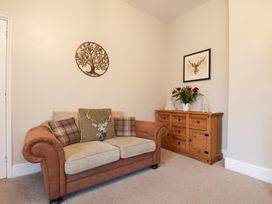 A living room with a sofa and sideboard at The Lodge in Snainton near Scarborough