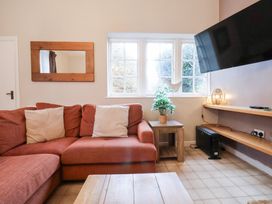 A living room with a sofa and a television at The Lodge in Snainton near Scarborough