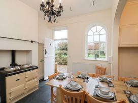 A kitchen with a dining table and chairs at The Lodge in Snainton near Scarborough