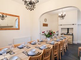 A dining room with a long table set for a meal at The Lodge in Snainton near Scarborough