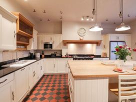 A kitchen with a cooking area, cabinets, and a kitchen island at The Lodge in Snainton near Scarborough