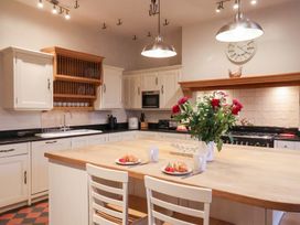 A kitchen with an island and flowers at The Lodge in Snainton near Scarborough