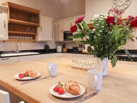 A kitchen with croissants and strawberries on a table at The Lodge in Snainton near Scarborough