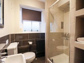 A bathroom with a toilet, sink, and shower at The Lodge in Snainton near Scarborough
