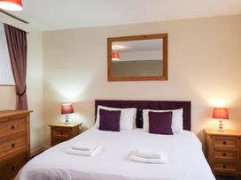 A bedroom with a bed and bedside tables at The Lodge in Snainton near Scarborough