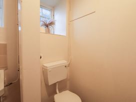 A bathroom with a toilet and a window at The Lodge in Snainton near Scarborough