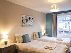 A bedroom with twin beds and a window at The Lodge in Snainton near Scarborough