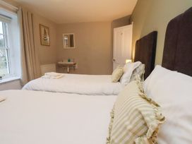 A bedroom with twin beds and a bedside table at The Lodge in Snainton near Scarborough