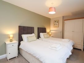A bedroom with twin beds and bedside tables at The Lodge in Snainton near Scarborough