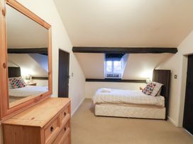 A bedroom with a bed and a mirror at The Lodge in Snainton near Scarborough