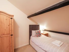 A bedroom with a bed and wardrobe at The Lodge Snainton near Scarborough