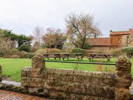 A garden with benches and trees at The Lodge in Snainton near Scarborough
