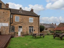 An outdoor view of a house with garden and seating at The Lodge Snainton near Scarborough