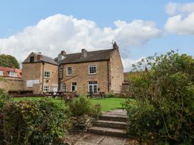 A building with tables and grass area at The Lodge in Snainton near Scarborough
