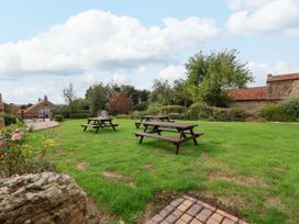A garden with picnic tables and greenery at The Lodge in Snainton near Scarborough