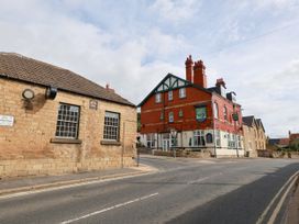 A street scene with buildings and road at The Lodge in Snainton near Scarborough