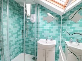 A bathroom with a shower and sink at Broom Cottage East Rudham near Fakenham