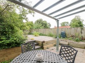 A garden with a table and chairs at Broom Cottage East Rudham near Fakenham