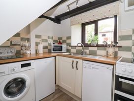 A kitchen with appliances and a sink at Wethercote Cottage in Old Byland near Helmsley
