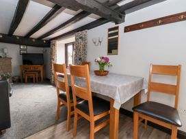 A dining room with a table and chairs at Wethercote Cottage in Old Byland near Helmsley