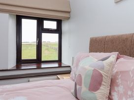 A bedroom with a window and bed at Wethercote Cottage in Old Byland near Helmsley