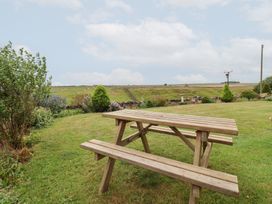 A picnic table in a garden at Wethercote Cottage in Old Byland near Helmsley