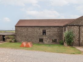 An outdoor area with a stone building and a pet house at Wethercote Cottage Old Byland near Helmsley