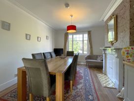 A dining room with a large table and chairs at Sterling House in Robin Hood's Bay