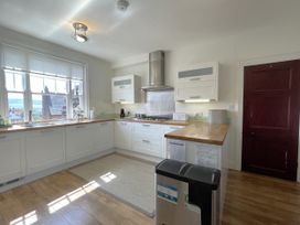 A kitchen with cabinets and appliances at Sterling House in Robin Hood's Bay
