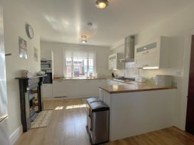 A kitchen with modern appliances and wooden countertop at Sterling House in Robin Hood's Bay