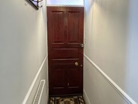 A hallway with a door and coat hook at Sterling House in Robin Hood's Bay