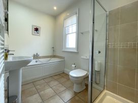 A bathroom with a shower and bathtub at Sterling House in Robin Hood's Bay