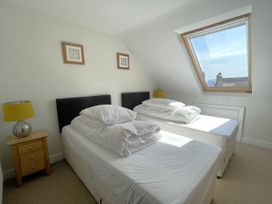 A bedroom with two beds and a window at Sterling House in Robin Hood's Bay