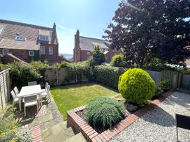 A garden with a table and chairs at Sterling House in Robin Hood's Bay