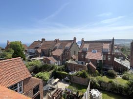 A view of houses and gardens overlooking the sea at Sterling House in Robin Hood's Bay