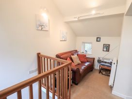 A snug with a sofa and wall artwork at Wood Cottage in Kendal