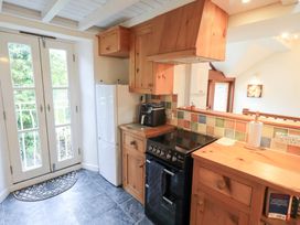 A kitchen with a fridge and cooker at Wood Cottage in Kendal