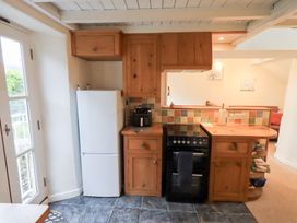 A kitchen with a refrigerator and stove at Wood Cottage in Kendal
