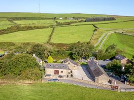 An outdoor view of a farmhouse surrounded by fields at Woodside Barn Pennington near Ulverston