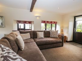 A living room with a sofa and windows at Woodside Barn Pennington near Ulverston
