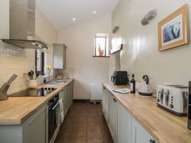 A kitchen with cabinets and appliances at Woodside Barn Pennington near Ulverston