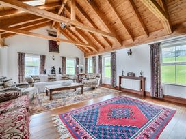 A living room with a coffee table and windows at Chapel Green in Polgooth