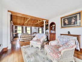 A living room with a sofa and armchairs at Chapel Green in Polgooth