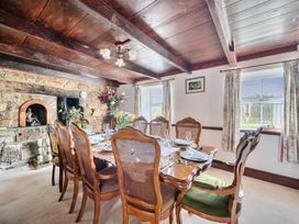 A dining room with a table set for meals at Chapel Green in Polgooth