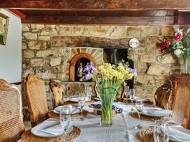 A dining room with a table set for a meal at Chapel Green in Polgooth