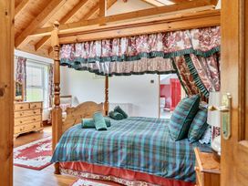 A bedroom featuring a four-poster bed and a dressing table at Chapel Green in Polgooth