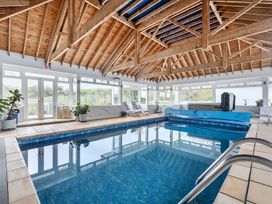 An indoor pool area with a hot tub at Chapel Green in Polgooth