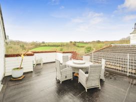 An outdoor area with a table and chairs at Chapel Green in Polgooth