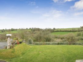 A garden with a lamp post and potted plants at Chapel Green in Polgooth